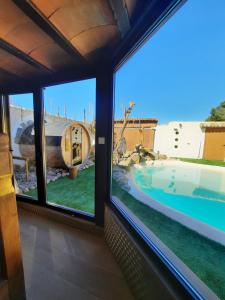 a view from the window of a house with a swimming pool at LA TEULERIA DE LINYOLA in Linyola