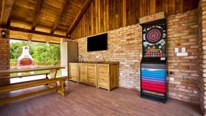 a room with a dart board on a brick wall at Villa 77 by Villas Guide in Sisak