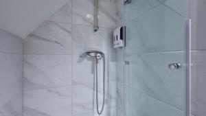 a bathroom with a shower with a glass door at Villa 77 by Villas Guide in Sisak +31 photos