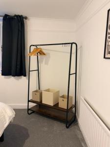 a room with a shelf with boxes on it at The Dearham Lonnin Nook in Dearham +11 photos
