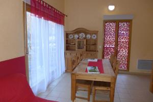 a kitchen with a wooden table and a dining room at Valériane in Froncles