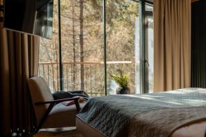 a bedroom with a bed and a large window at Veres Hill in Tukhlya