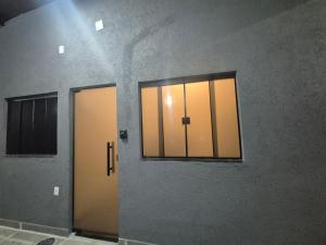 two elevators in a room with two windows at Kitnet Vale do Amanhecer - Templo Mãe in Planaltina