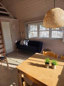a living room with a table and a couch at Riis Feriepark in Give
