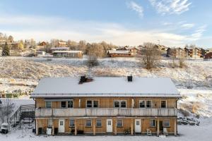 a house in the snow with snow covered ground at Olen Village - Funäsdalen in Funäsdalen