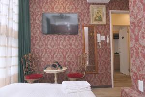 a bedroom with a bed and a tv on a wall at Hotel Bali Yokohama in Yokohama