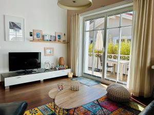 a living room with a table and a large window at Strandquartier 31 "Quartier 2" in Wustrow