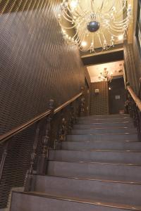 a staircase in a building with a chandelier at Hotel Bali Yokohama in Yokohama