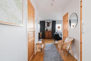 a room with a hallway with a couch and a table at Olen Village - Funäsdalen in Funäsdalen +8 photos