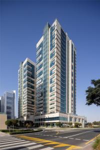 two tall buildings in a city with a street at Radisson Blu Hotel, Dubai Barsha Heights in Dubai