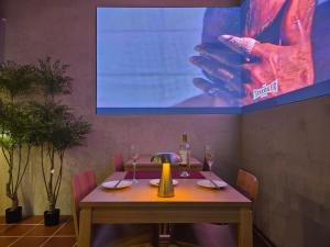 a table in a restaurant with a picture of a hand at Quantum Hotel, Seoul Station br in Seoul
