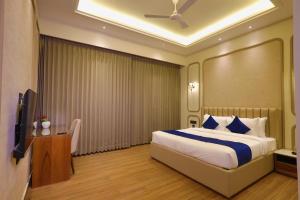 a hotel room with a bed and a television at BB Grand in Sunām