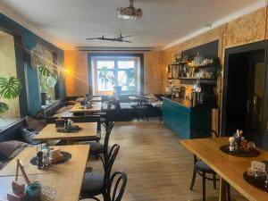 a room with tables and chairs and a living room at Pension Edlinger in Mallnitz