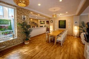 a dining room with a wooden table and chairs at Hostal Mar del Plata in El Arenal