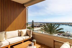 a living room with a couch and a view of the ocean at Apartamento Pink Frontline Premium in Torrevieja