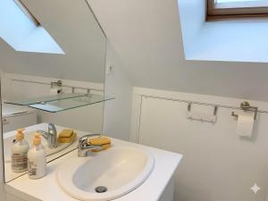 a white bathroom with a sink and a mirror at Maison duplex centre plage port cabine in Le Crotoy +35 photos