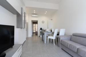 a living room with a couch and a dining room at The Sea Under the House in Marina di Strongoli