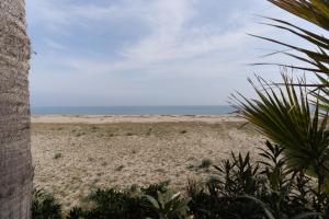 a sandy beach with the ocean in the background at The Sea Under the House in Marina di Strongoli