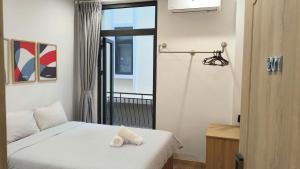 a bedroom with a bed with two towels on it at LokoOne Central Hub in Hòa Bình +14 photos