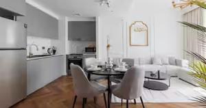 a kitchen and living room with a table and chairs at Burj Khalifa View & Creek lagoon in Dubai