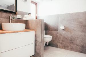 a bathroom with a sink and a toilet at Haus Luna - Apartment Luna 6 in Schwangau +8 photos