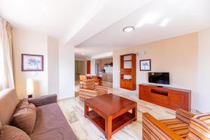a living room with a couch and a table at Apartamentos Vista Sur in Playa de las Americas