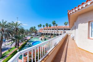 a balcony with palm trees and a resort at Apartamentos Vista Sur in Playa de las Americas