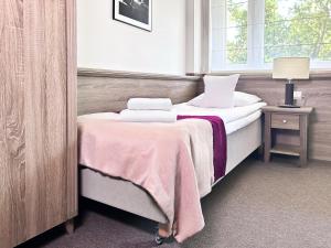 a bedroom with a bed with two towels on it at WILla Medica in Poznań