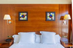 a bedroom with a white bed with two lamps at Moon Dreams Portomagno in Aguadulce