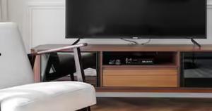 a flat screen tv sitting on top of a wooden entertainment center at Burj Khalifa View & Creek lagoon in Dubai