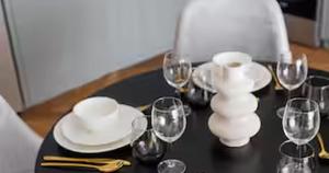 a black table with wine glasses and plates on it at Burj Khalifa View & Creek lagoon in Dubai +19 photos