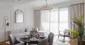 a white living room with a table and a couch at Burj Khalifa View & Creek lagoon in Dubai