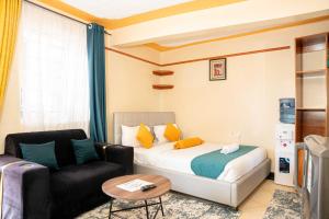 a hotel room with a bed and a couch at Nelly fully furnished studios in Naivasha