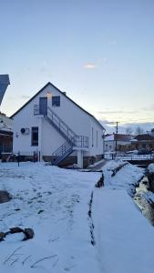 a large white building with snow on the ground at MANSARD - Bozsok in Bozsok +6 photos