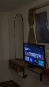 a television sitting on a shelf in a room at Lex Apartments KS in Prizren