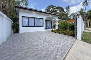 a house with a driveway in front of it at Samui Kozy Private Pool Villa in Nathon Bay