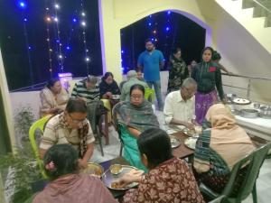 a group of people sitting around a table eating at Narayan homestay guesthouse in Ayodhya