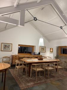 a dining room with a large wooden table and chairs at Casa Vidinha in Faria de Baixo