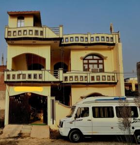 a white van parked in front of a building at Narayan homestay guesthouse in Ayodhya