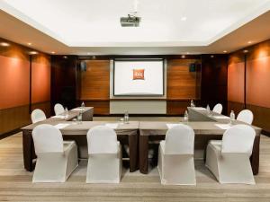 a conference room with a large table and white chairs at ibis Samui Bophut Hotel in Bophut +104 photos