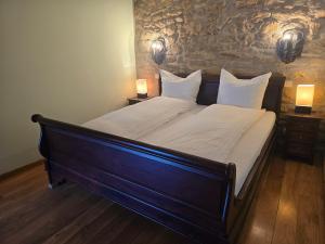 a large bed in a room with two lamps at Apartment in a Chateau with Park in Trébry