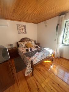 a bedroom with a bed and a wooden floor at Dreams in Xisto in Piódão