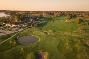 an aerial view of a golf course with a pond at Körunda Golf & Conference Hotel in Ösmo