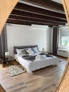 a bedroom with a large bed and a large window at Dori Affittacamere in San Lorenzo