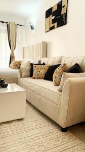 a living room with a couch and a coffee table at Brizelle studio in Ongata Rongai 
