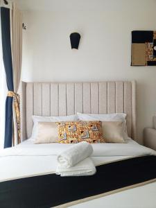 a bed with white sheets and pillows in a room at Brizelle studio in Ongata Rongai  +16 photos