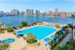 a large swimming pool with a view of the city at Hilton Cairo Grand Nile in Cairo