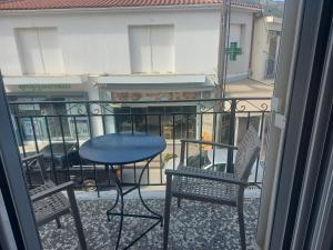 a balcony with two chairs and a table on a balcony at Karafelas rooms in Skiathos