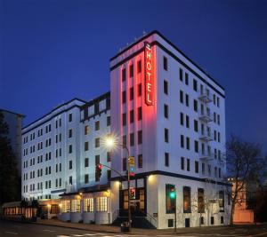 a white building with a red neon sign on it at Graduate by Hilton Berkeley in Berkeley