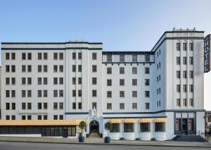 a large white building with a building at Graduate by Hilton Berkeley in Berkeley